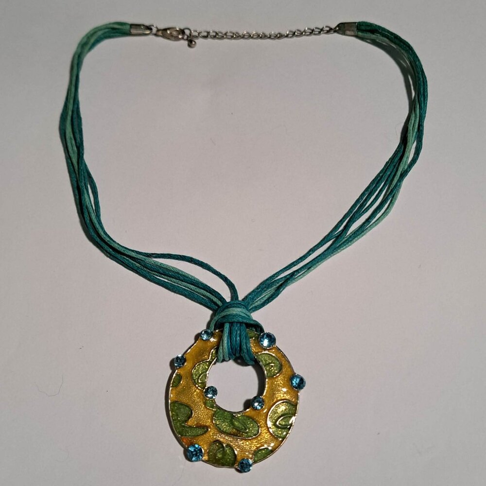 green and turquoise multistranded necklace with yellow and green round pendant